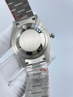 Rolex silver watch case with ridged bezel and link bracelet, crown and side buttons