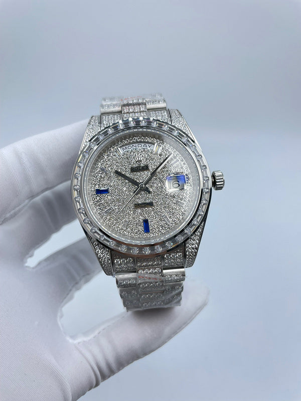 Rolex diamond bezel watch with silver bracelet and blue hour markers, front view