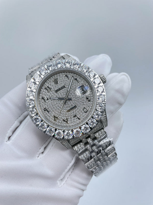 Diamond bezel wristwatch with dark dial and textured silver bracelet links