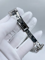 Watch clasp and black strap detail with silver hardware and stones