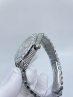 Diamond-studded watch band detail with round silver case clasp