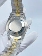 Rolex wristwatch side view with crown and two-tone bracelet links