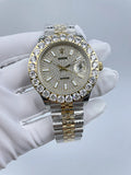Rolex wristwatch with diamond bezel, gold-and-silver bracelet, sparkling dial