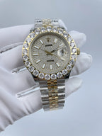 Rolex wristwatch with diamond-studded bezel, light sparkling dial, gold crown, two-tone bracelet