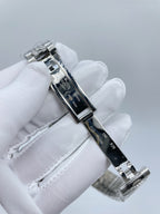 Silver-tone wristwatch side profile with crown and clasp, white glove