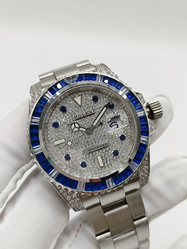 Rolex stainless steel watch with blue bezel and silver dial showing Submariner text