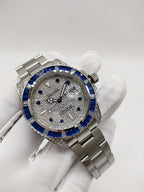 Rolex stainless steel watch with blue bezel and silver speckled dial on bracelet