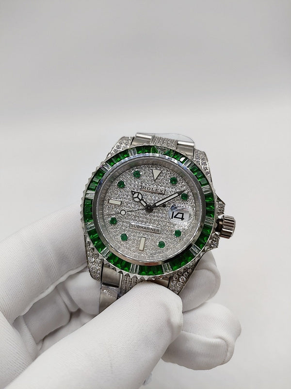Rolex Submariner watch front view with green accents, silver case and link bracelet