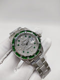 Rolex Submariner watch with green bezel, silver bracelet, diamond-style bezel detail