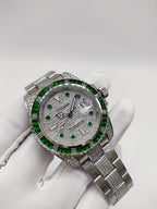 Rolex Submariner watch with green bezel, silver bracelet, diamond-style bezel detail