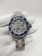 Stainless steel wristwatch with blue bezel, silver dial, and metal bracelet
