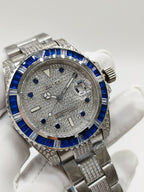 Stainless steel wristwatch with blue bezel and silver dial, close-up