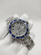 Stainless steel wristwatch with blue bezel and silver dial on a metal bracelet