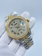 Rolex two-tone wristwatch with diamond bezel, Roman numeral dial, and gold-toned crown