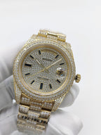 Gold-tone diamond watch face with black hour markers and date window