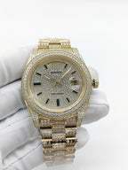 Gold-tone diamond watch with round dial, gold hands, and studded bezel