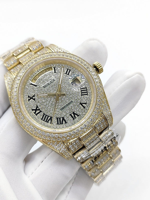 Gold-tone diamond watch with champagne dial, Roman numerals, crown and bracelet detail