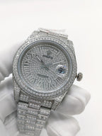 Diamond-set silver analog watch from an angle, textured dial with gem accents