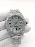 Rolex diamond-accent watch with silver dial, Roman numerals, and jeweled bezel