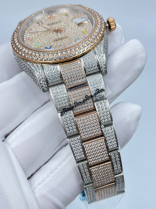 Rolex watch top view with diamond bezel, multicolor dial, and full bracelet