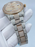 Rolex watch top view with diamond bezel, multicolor dial, and full bracelet
