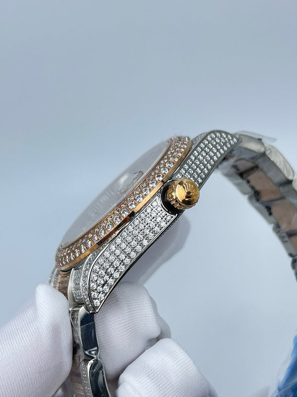 Rolex watch side view with diamond bezel, gold-tone crown, and metal mesh bracelet