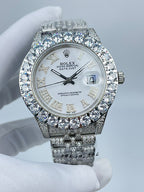 Rolex Datejust diamond bezel watch with silver-tone bracelet, white dial, and date window at 3