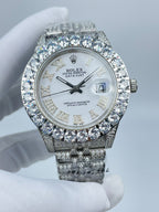 Rolex Datejust diamond bezel watch with silver-tone bracelet, white dial, and date window at 3