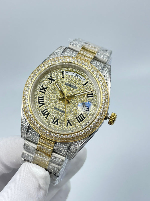 Rolex diamond bezel watch front view with gold dial, Roman numerals, and date