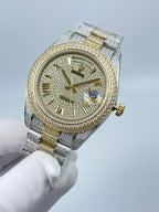 Diamond-encrusted two-tone watch with round champagne dial, gold accents, gold crown