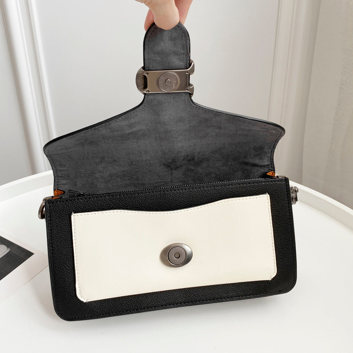 Coah bag small crossbody with black flap, white front panel, silver snap closure