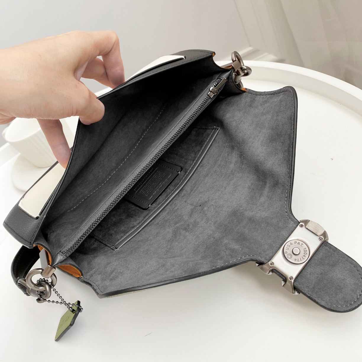 Coah bag open tote with gray lining, zipper details, adjustable shoulder strap