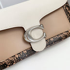 Coah bag close-up of front clasp and layered panels with light beige leather and patterned band.