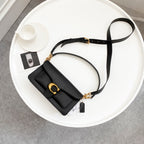 Coah bag black crossbody with flap, gold rings, and adjustable strap