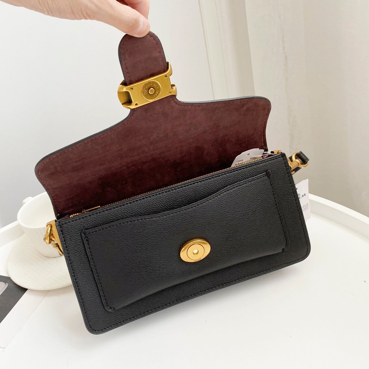 Coah bag burgundy suede-style crossbody with gold button closure and strap