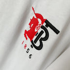 Close-up of Burberry red and black 1856 logo print on white T-shirt