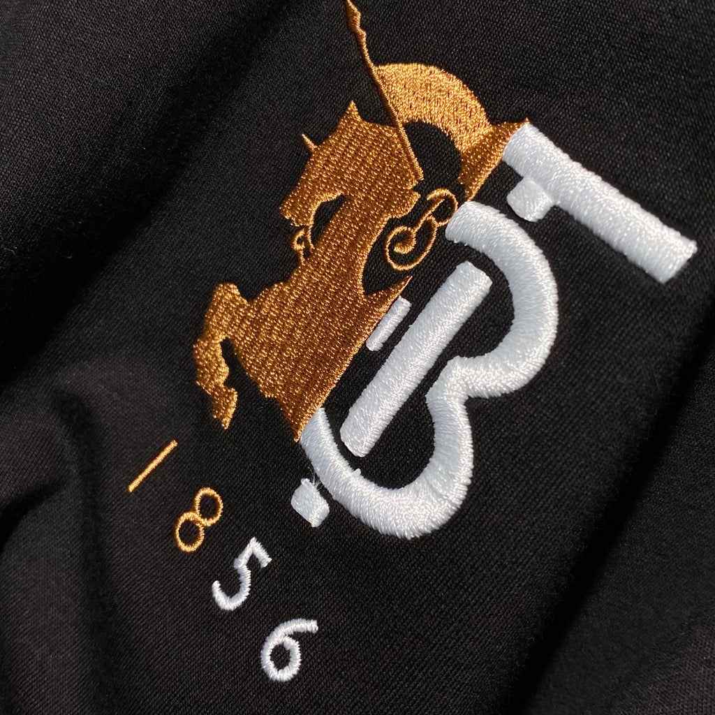 Close-up of Burberry 'B 1856' logo embroidery on black T-shirt