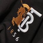 Close-up of Burberry 'B 1856' logo embroidery on black T-shirt