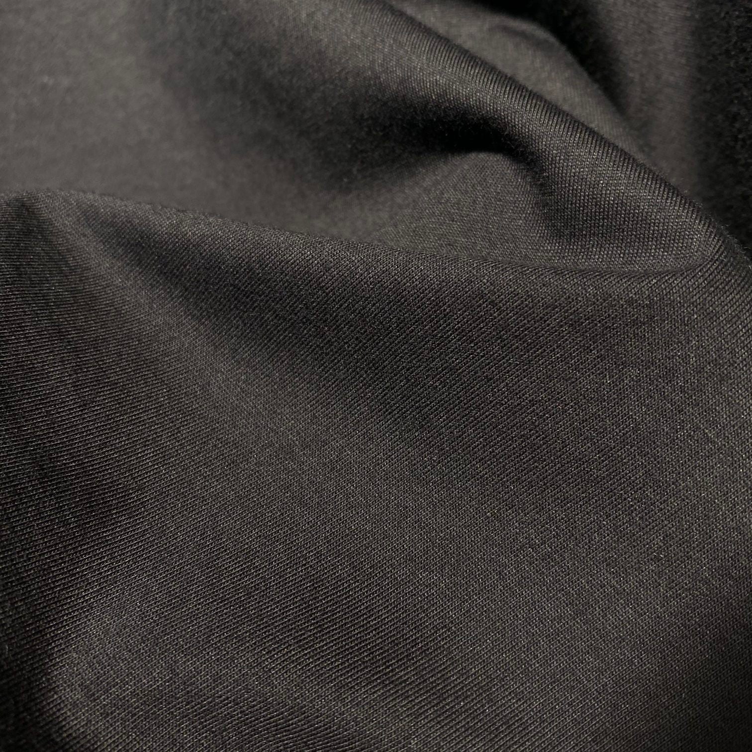 Dark T-shirt fabric close-up with fine woven texture