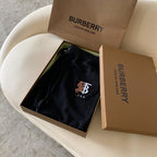 Black Burberry drawstring shorts folded in an open gift box
