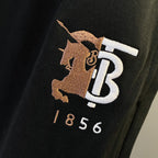 Black Burberry drawstring shorts with TB horse logo and 1856 print