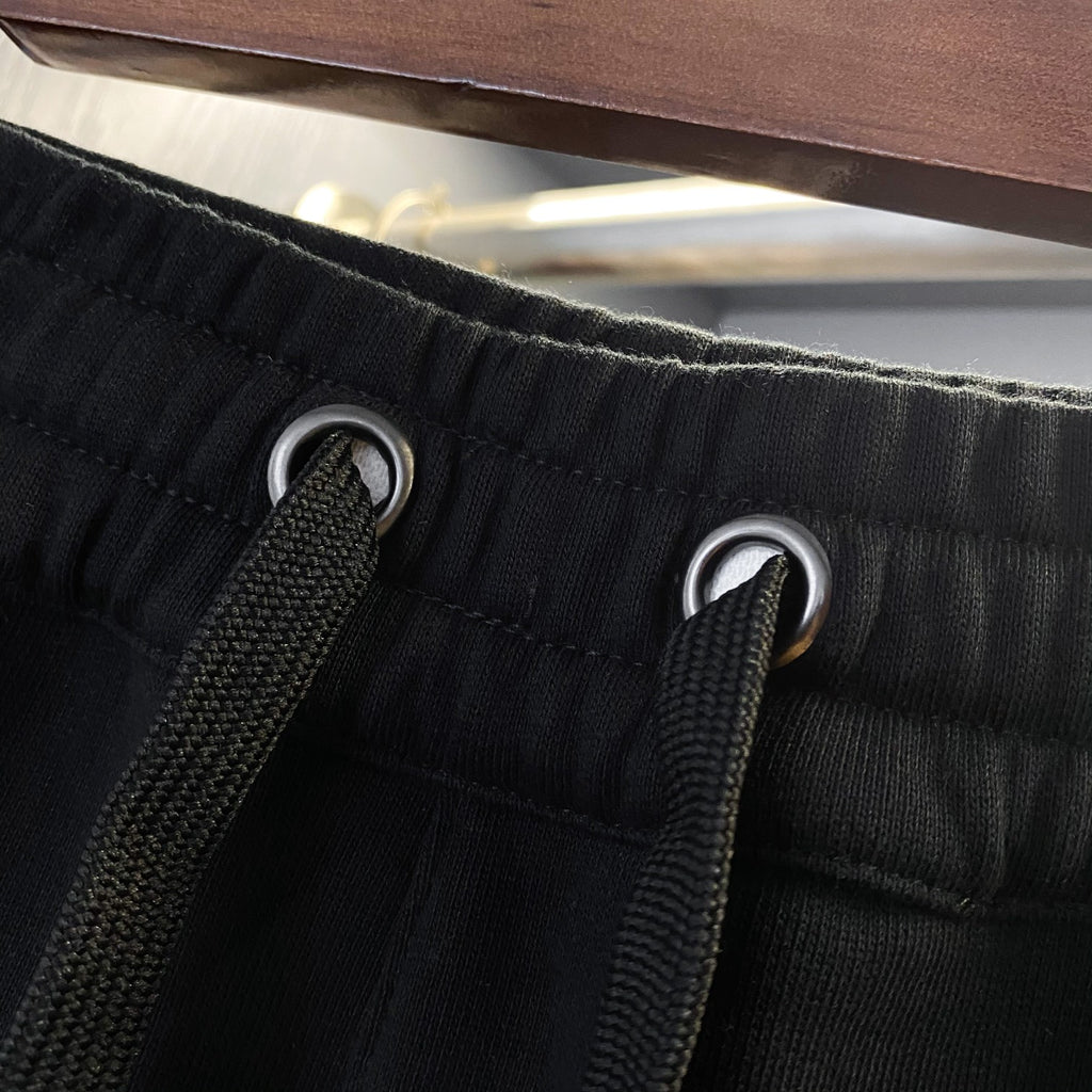 Black Burberry drawstring shorts with metal grommet eyelets and drawstring