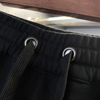 Black Burberry drawstring shorts with metal grommet eyelets and drawstring
