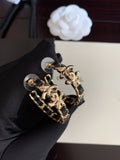 Gold-tone chain hoop earrings with black enamel links