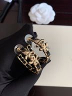 Gold-tone chain hoop earrings with black enamel links