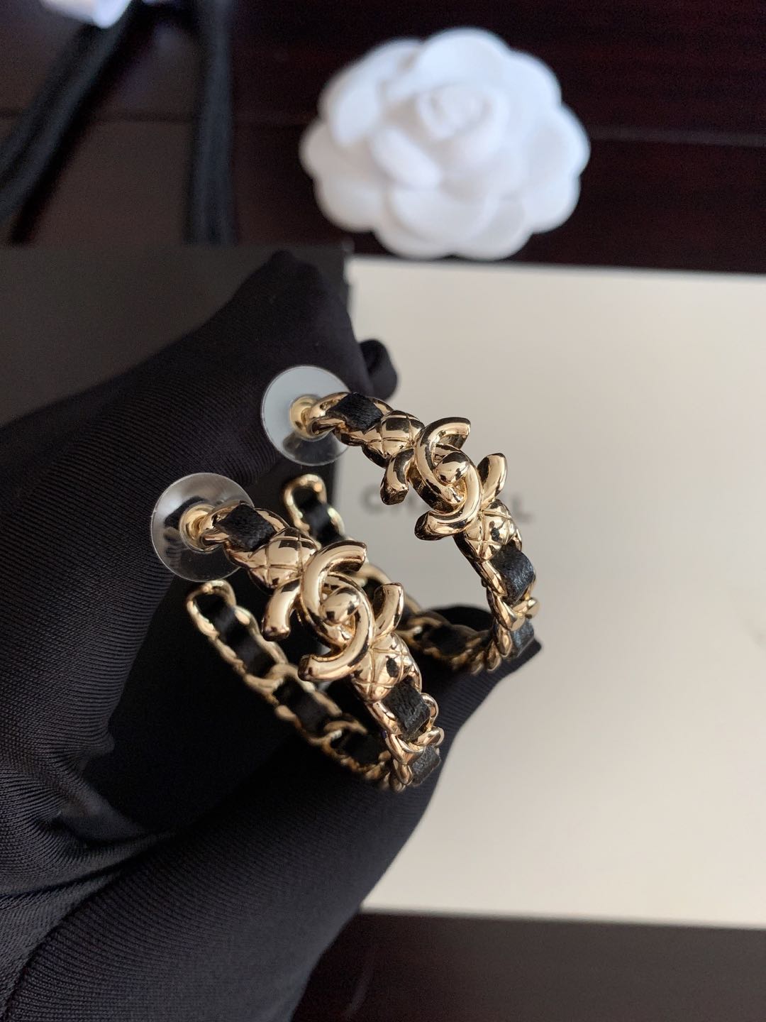 Gold-tone chain hoop earrings with black enamel links