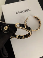 Gold-tone chain hoop earrings on CHANEL jewelry card