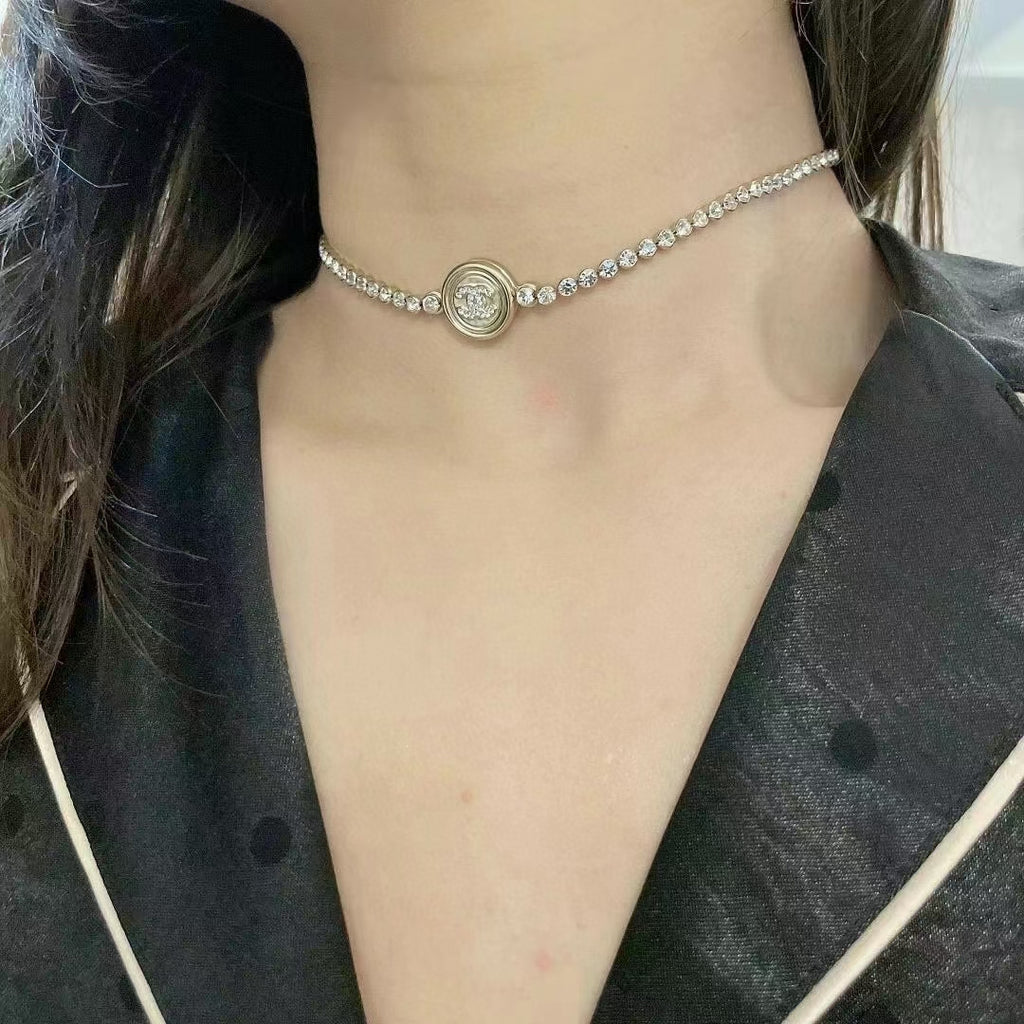 Silver-tone rhinestone choker necklace with round logo medallion pendant