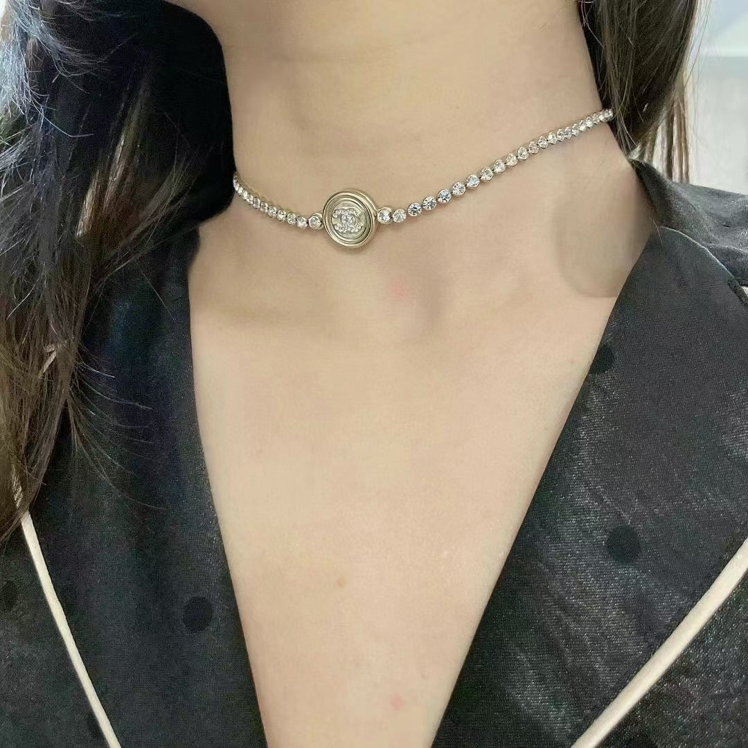 Silver-tone rhinestone choker necklace with round logo medallion pendant