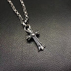 Silver-tone cross pendant necklace with curb chain links